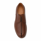 Détail du cuir grainé de la chaussure Derby marron